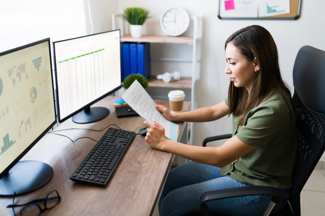 Young woman and sales representative going through work papers. Hispanic business manager working on a business deal from home